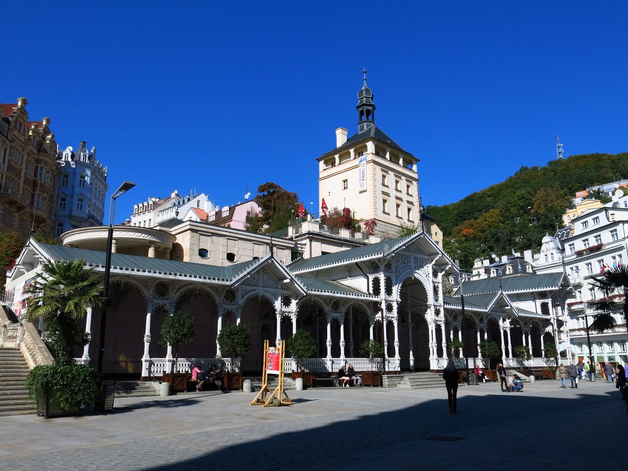 It is a long, white wooden spa building in the Swiss style, with lace-like arches and topped by a tower
